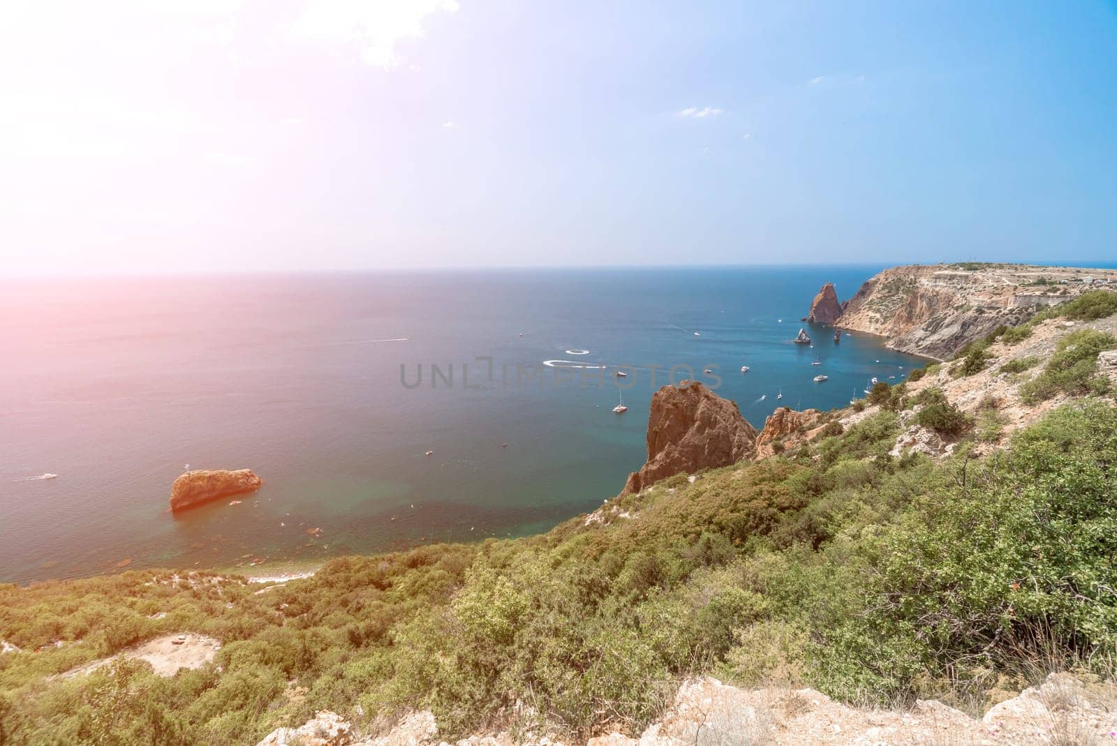 Aerial panoramic view of beautiful sunset above sea. Beautiful seascape. Sun glare, small waves on the water surface. Evening. Horizon. Nobody. No people. Copy space. Never-ending beauty of nature