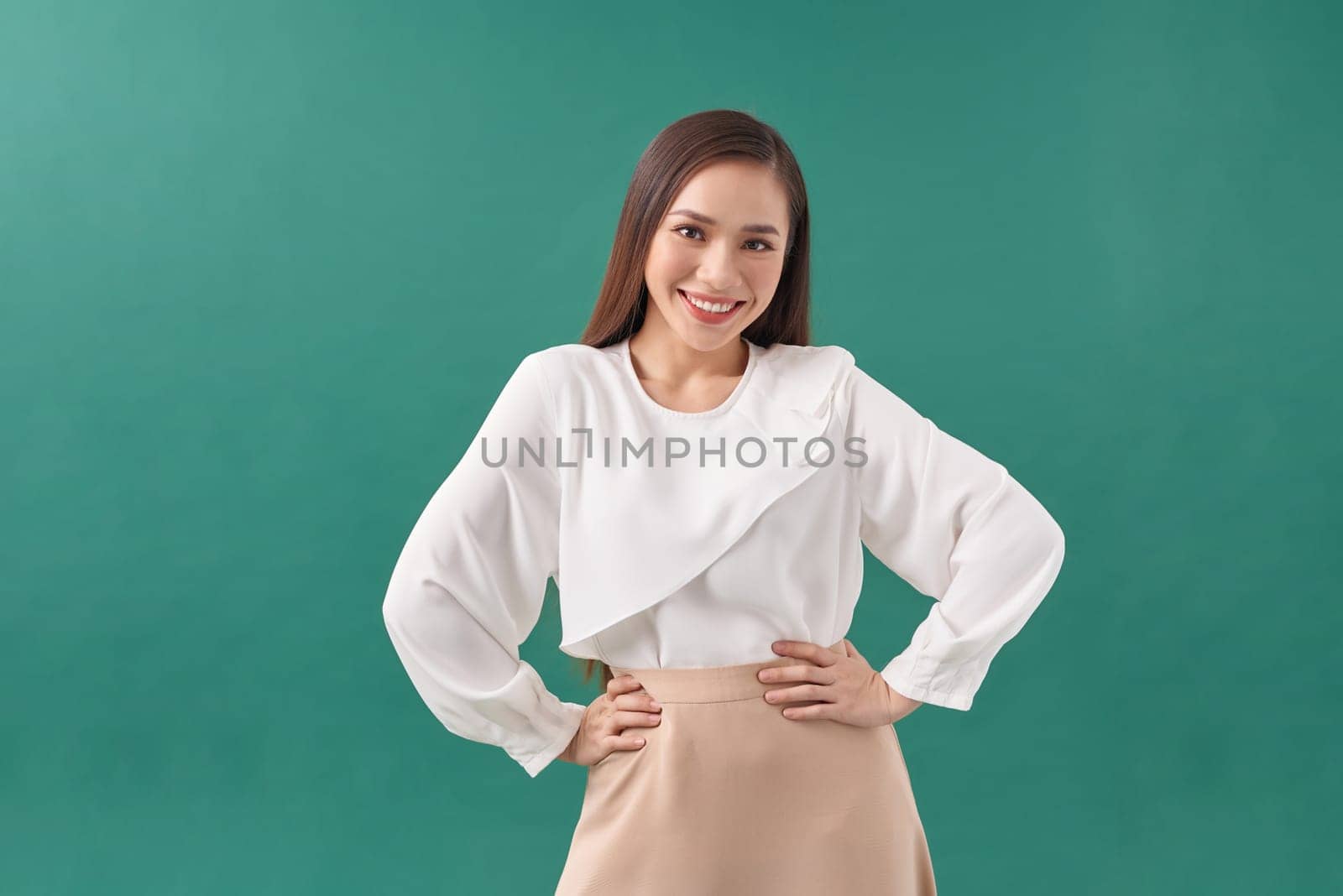 Image of happy young business woman posing isolated over green background.