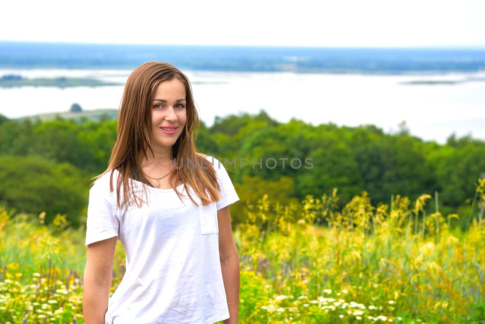 Cute young woman near the river bank with lush greenery by jovani68