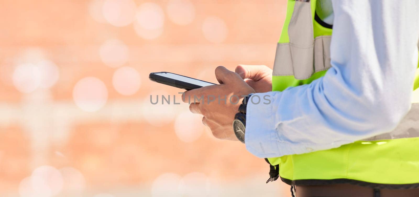 Hands of engineer on construction site, typing on phone and checking email for building schedule with mockup. Architecture, communication and business man with cellphone reading text, chat or report