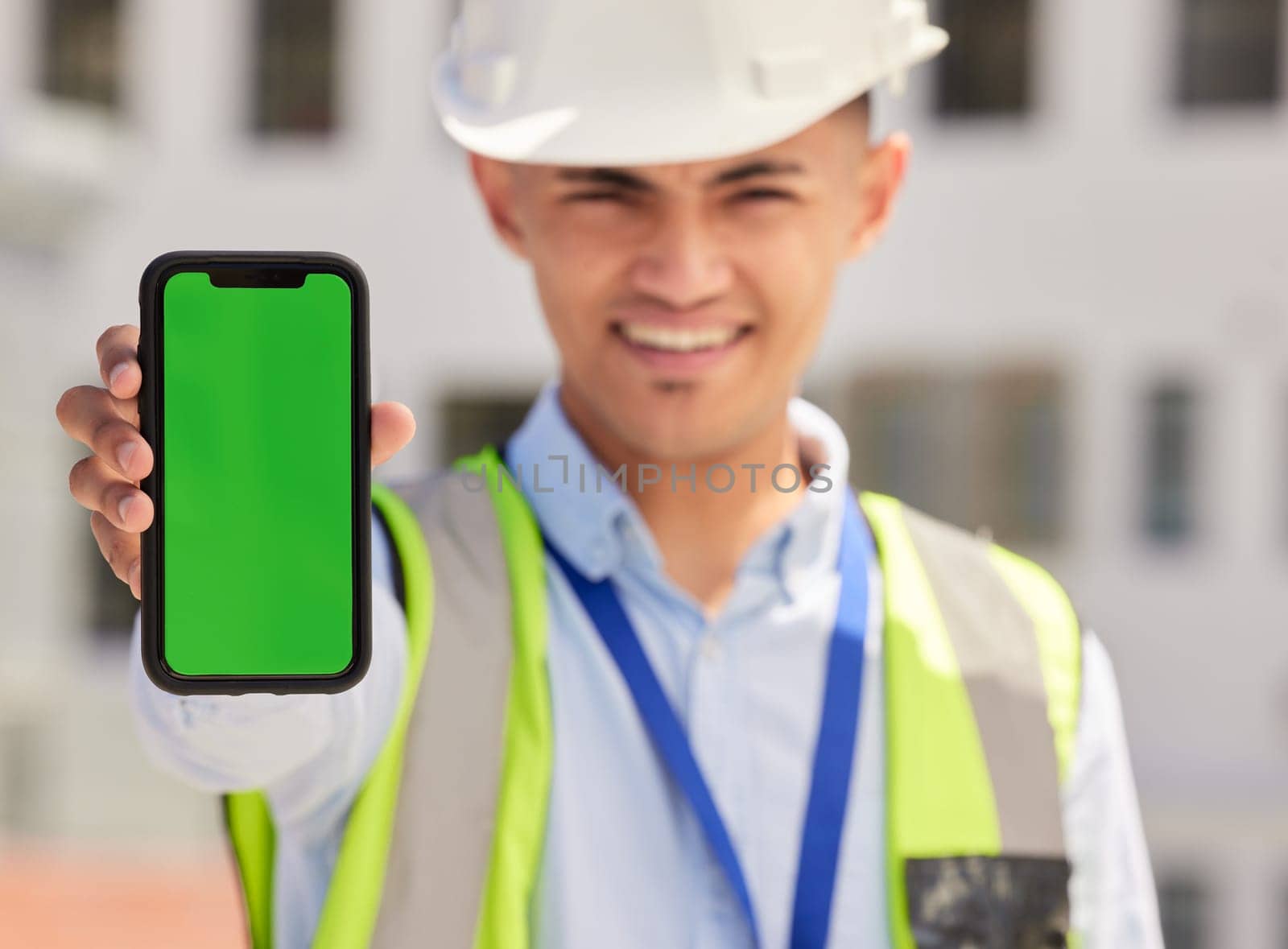 Engineering man, phone green screen and outdoor for contact information of architecture, renovation or design. Portrait, construction worker or builder and mobile app mockup or industrial advertising by YuriArcurs