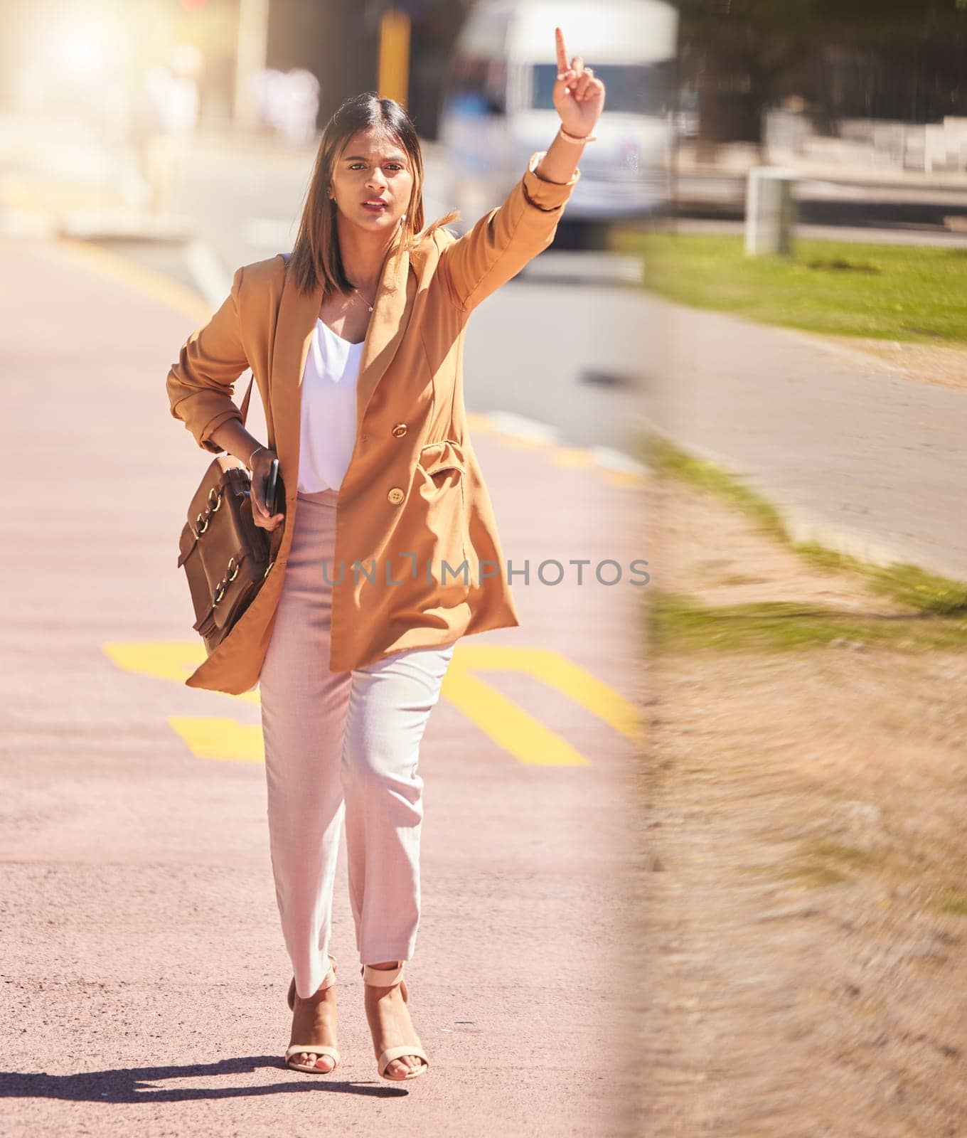 Woman, walking and wave to taxi in city for bus, cab or commute transportation and travel in cbd for business. Person, hand and sign to call attention of taxicab driver, service or passenger in town by YuriArcurs