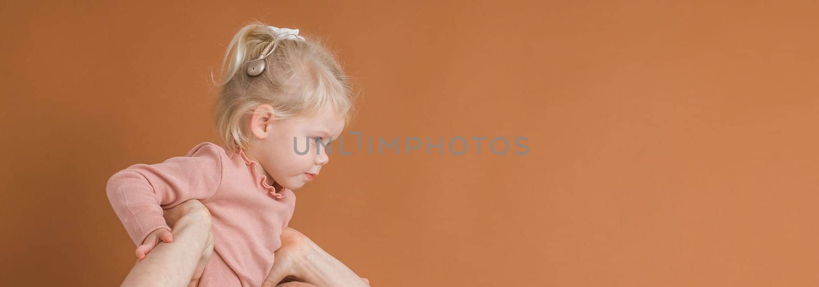 Banner copy space deaf child girl with cochlear implant studying to hear sounds and have fun - recovery after cochlear Implant surgery and rehabilitation concept by Satura86