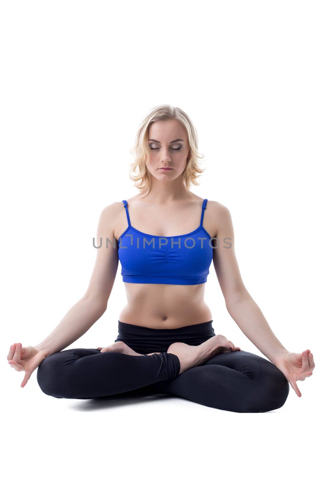 Beautiful woman meditates in studio, isolated on white