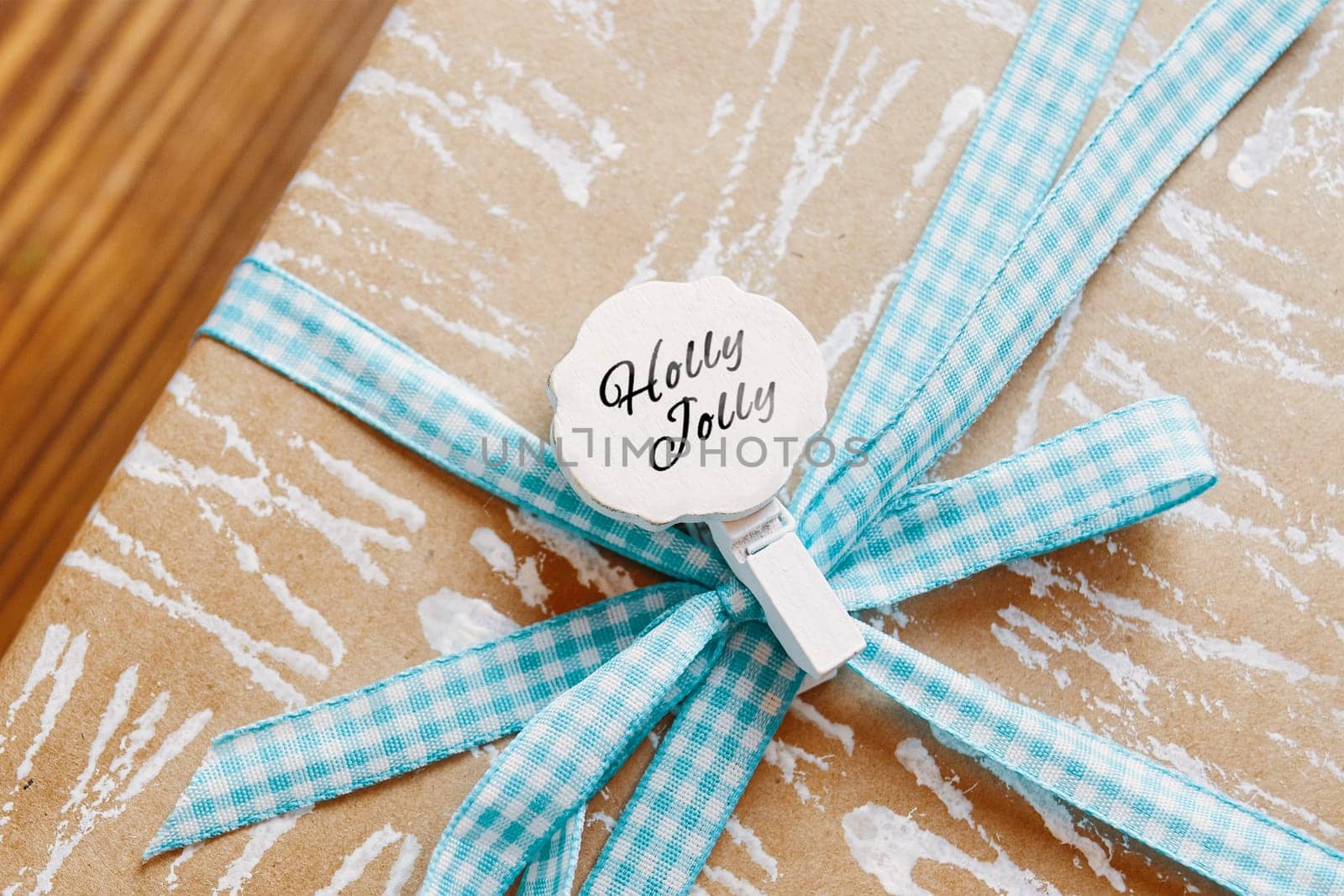 Little tag with Christmas wishes and gifts. Small label on the gift box that says Holly Jolly.