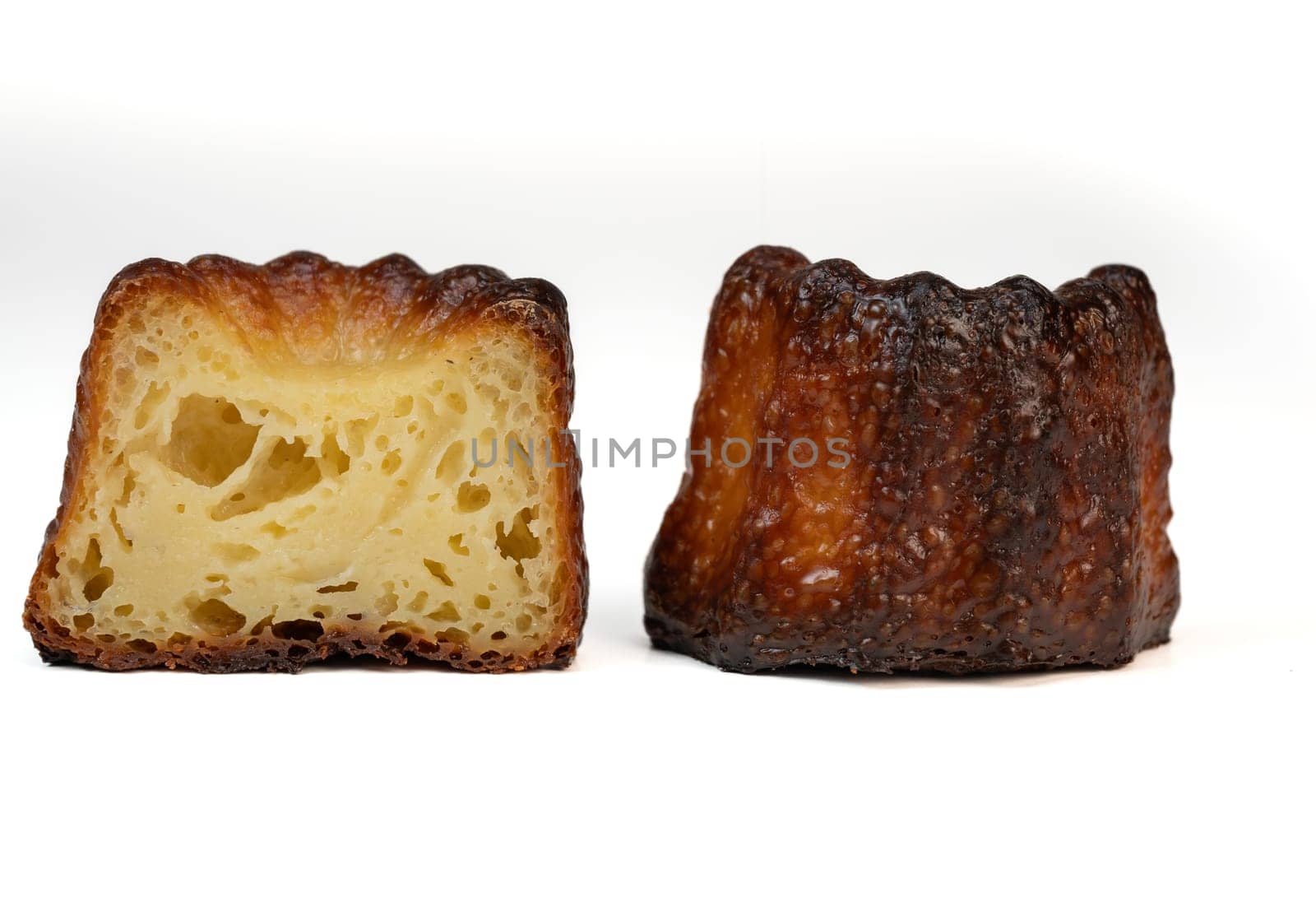 Caneles de bordeaux, traditional French sweet dessert with white table background, High quality photo