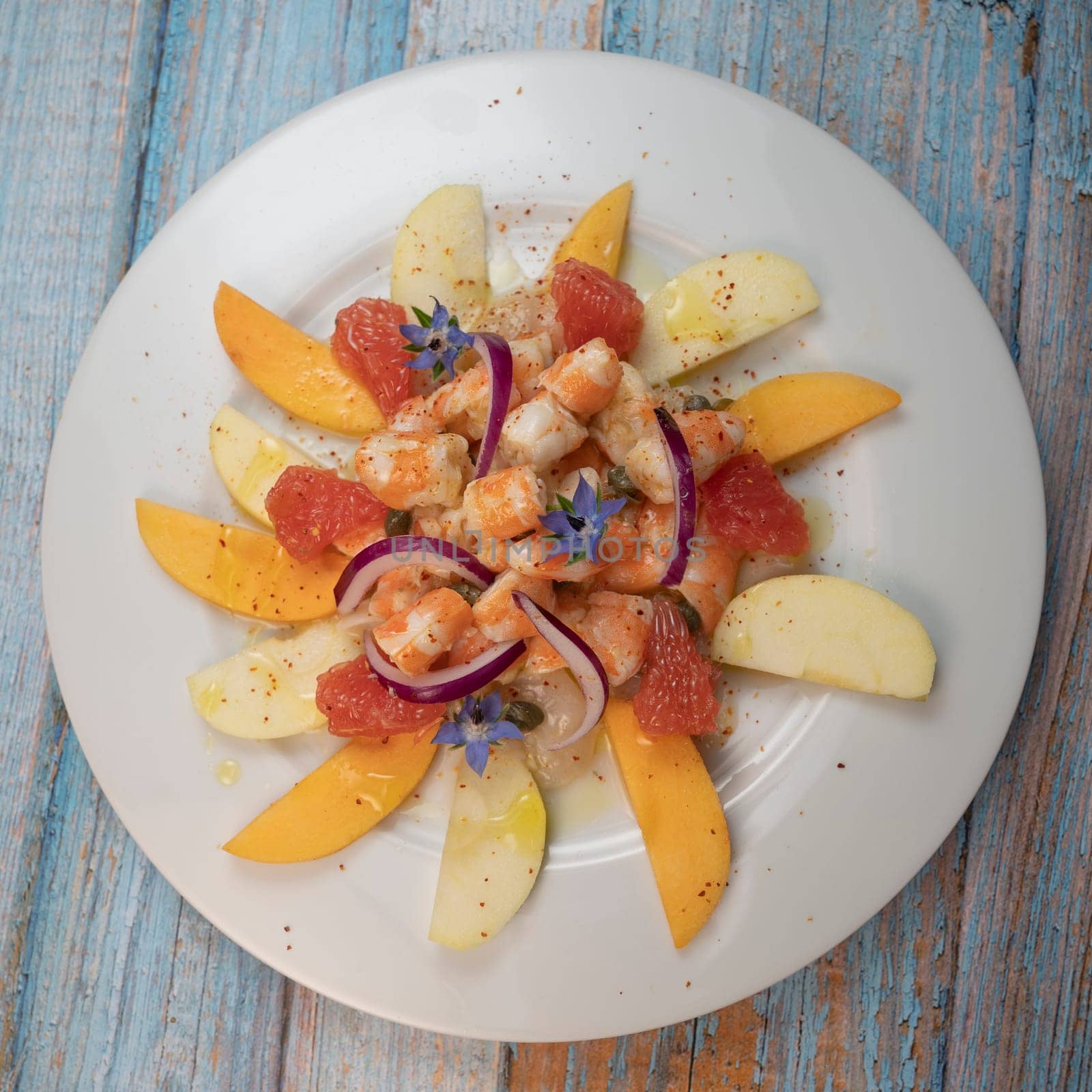 RECIPE CEVICHE OF SHRIMPS AND SCALLOPS WITH CITRUS FRUIT, LEMON, LIME, SQUEEZED ORANGE, GRAPEFRUIT AND FRUIT, PERSIMMON, APPLE, SEASONED WITH ESPELETTE PEPPER. High quality photo