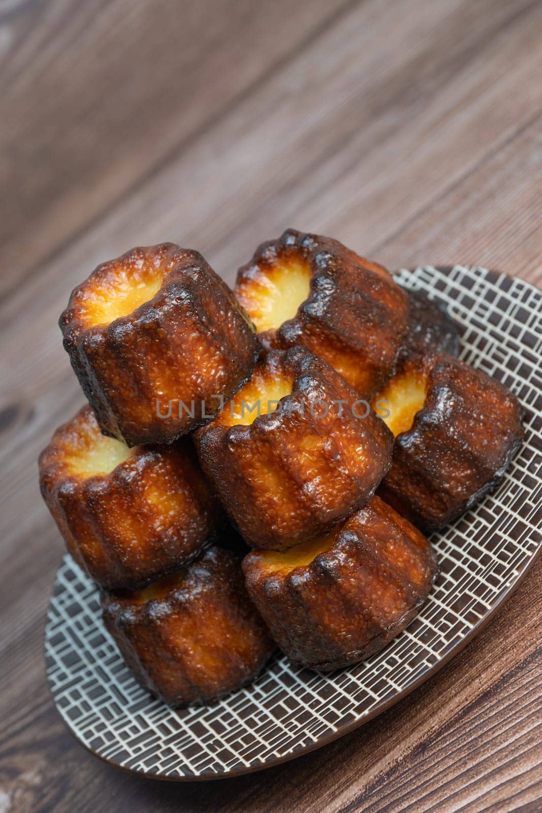 Caneles de bordeaux, traditional French sweet dessert with white table background, High quality photo