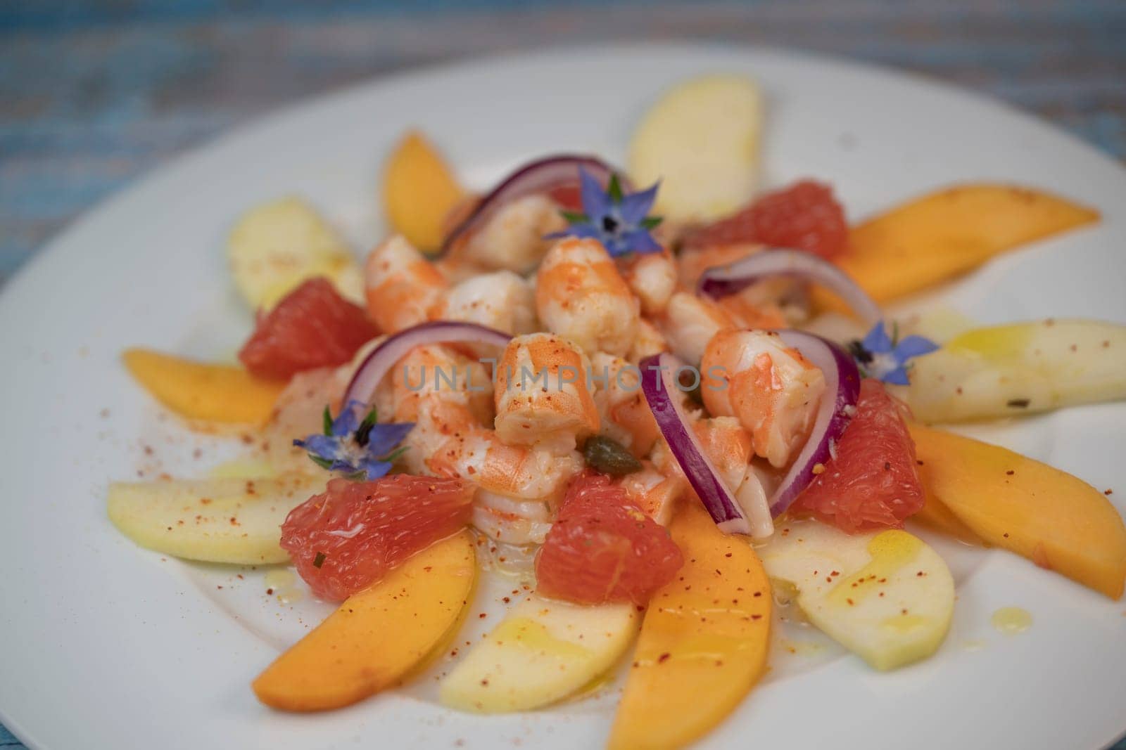 RECIPE CEVICHE OF SHRIMPS AND SCALLOPS WITH CITRUS FRUIT, LEMON, LIME, SQUEEZED ORANGE, GRAPEFRUIT AND FRUIT, PERSIMMON, APPLE, SEASONED WITH ESPELETTE PEPPER. High quality photo