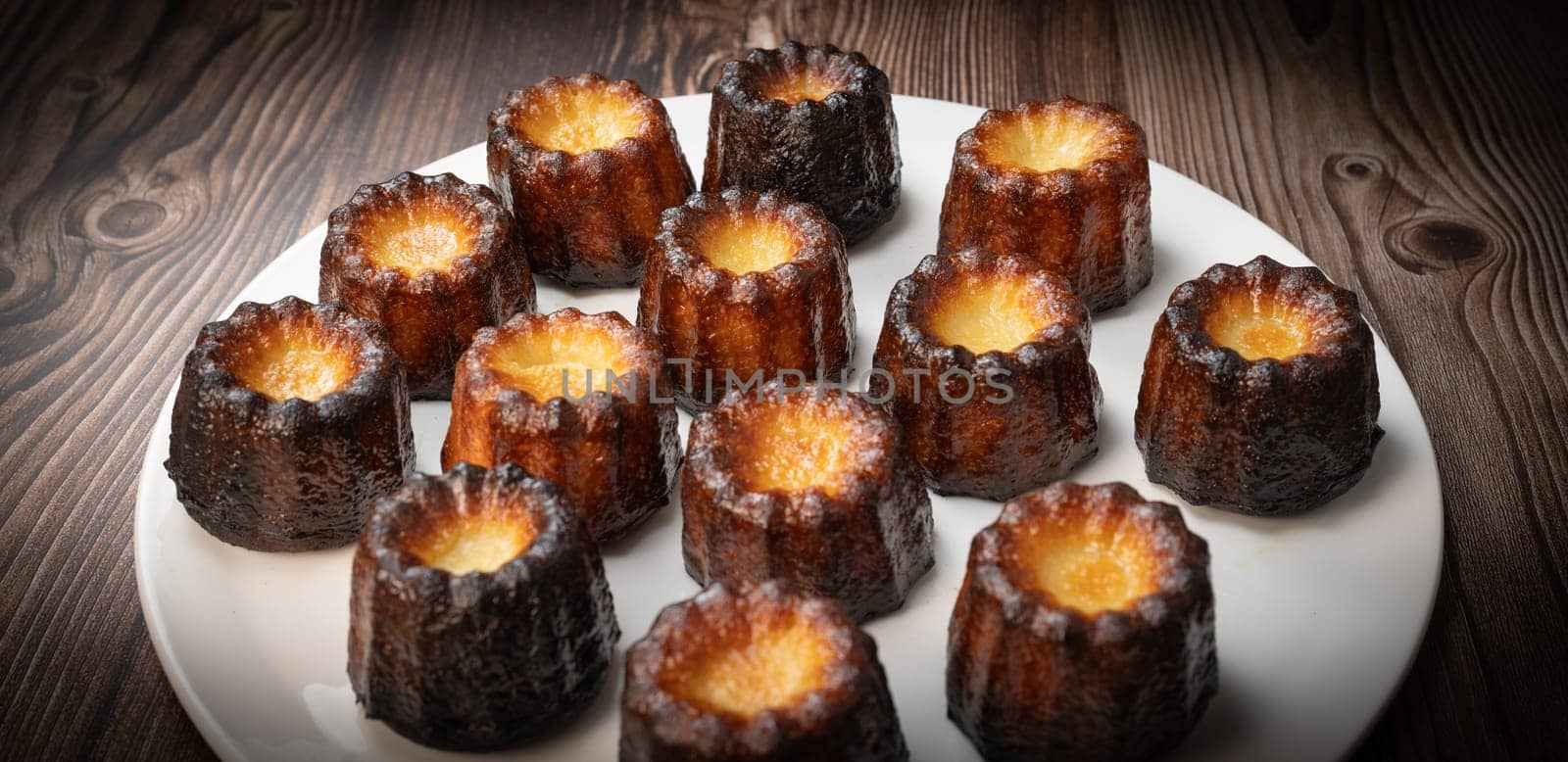 Caneles de bordeaux, traditional French sweet dessert with white table background, High quality photo