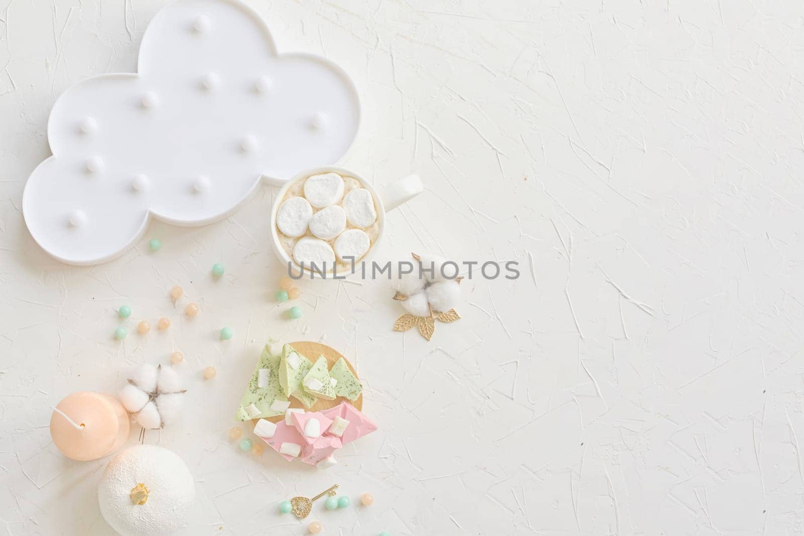 Charming pastel-colored dessert setup featuring marshmallows, a cloud plate, and decor on a white background.