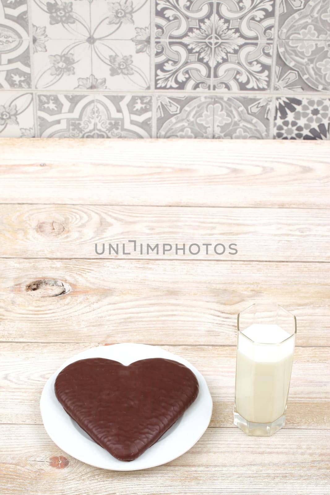 A delicious and decadent heartshaped chocolate cake, perfectly complemented by a refreshing glass of milk