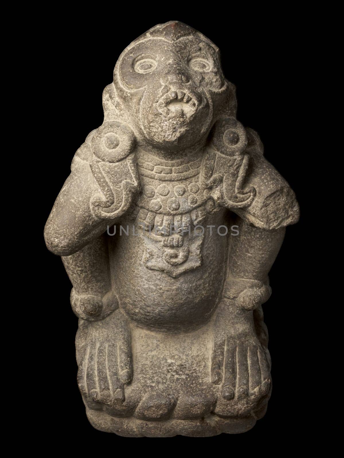 A stone sculpture of an Aztec spider monkey wearing the regalia of a wind god.