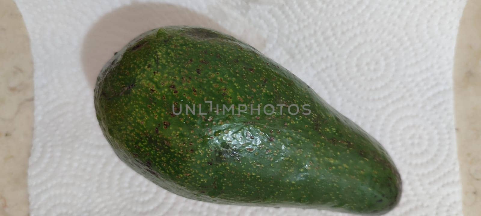 green avocado, fruit, healthy food, white background closeup . High quality photo