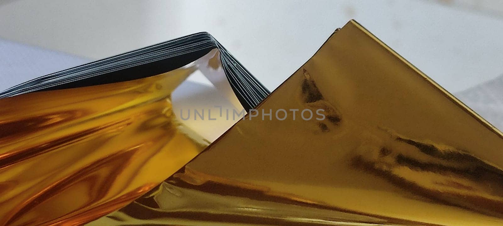 thin gold foil aluminum blanket background AliExpress souvenir texture, emergency blanket, abstract object on white background