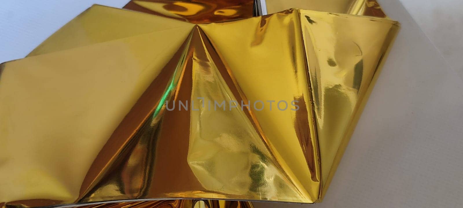 thin gold foil aluminum blanket background AliExpress souvenir texture, emergency blanket, abstract object on white background