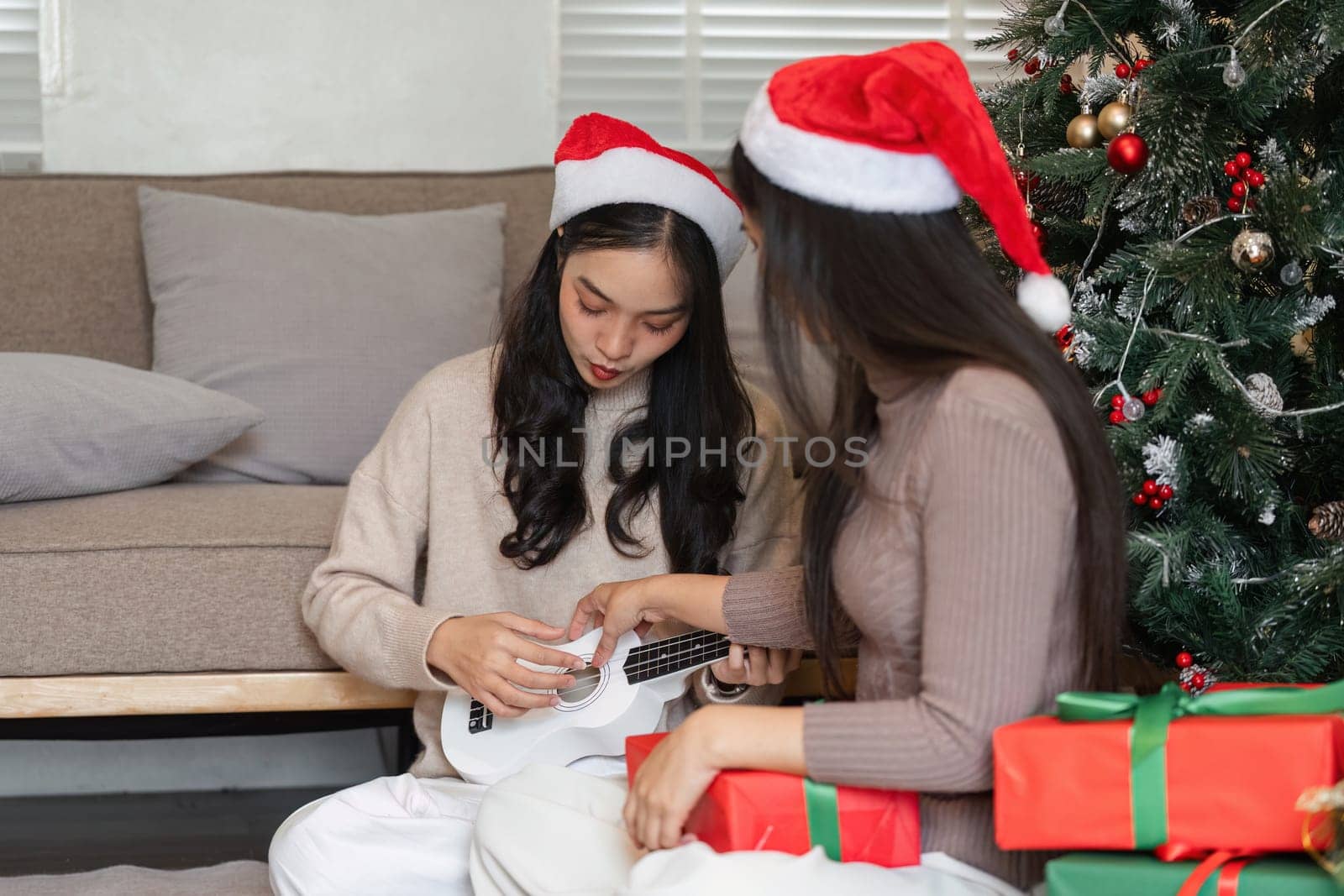 A young couple enjoys a festive Christmas party, exchanging gifts and celebrating in a cozy home environment.