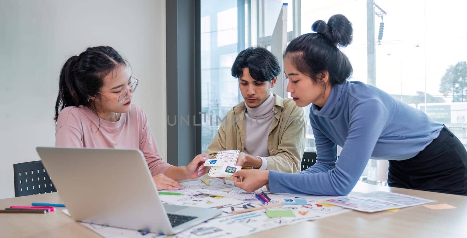 Asian office team brainstorming, plan for solution idea, Group of asia creative teamwork and woman leader at business meeting for developing mobile phone app, ux, ui start up, small business by wichayada