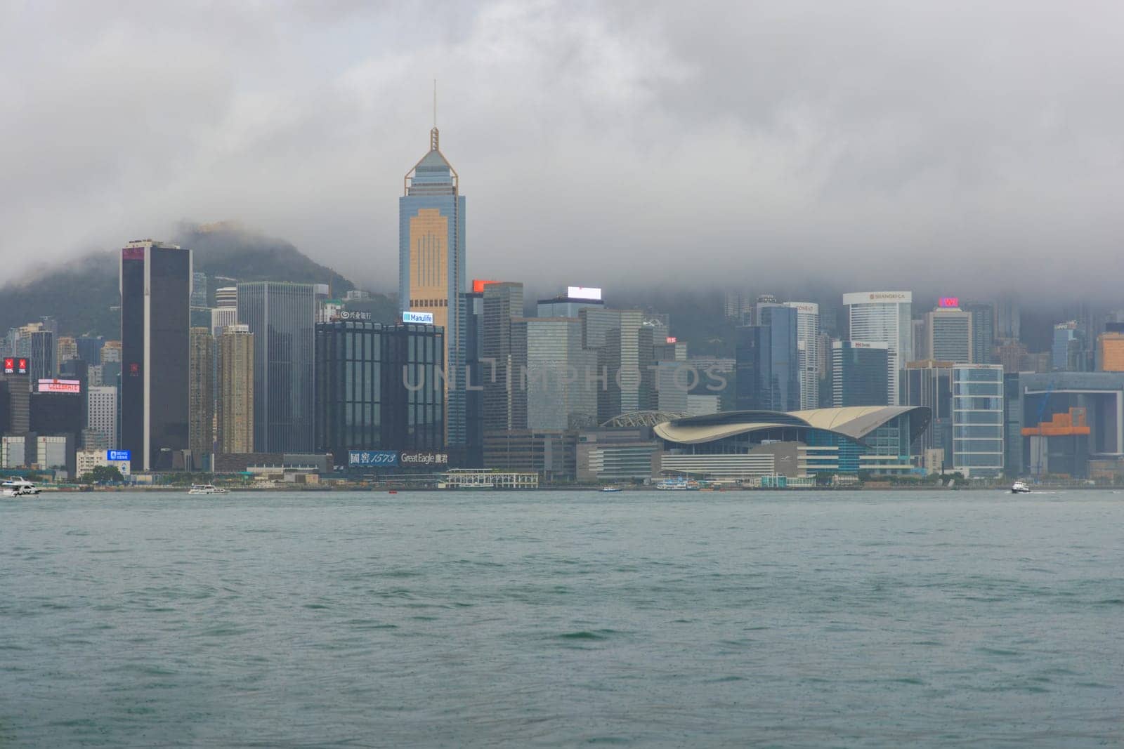 Hong Kong - September 4, 2023: Clouds and rain over city skyline at dusk. High quality photo