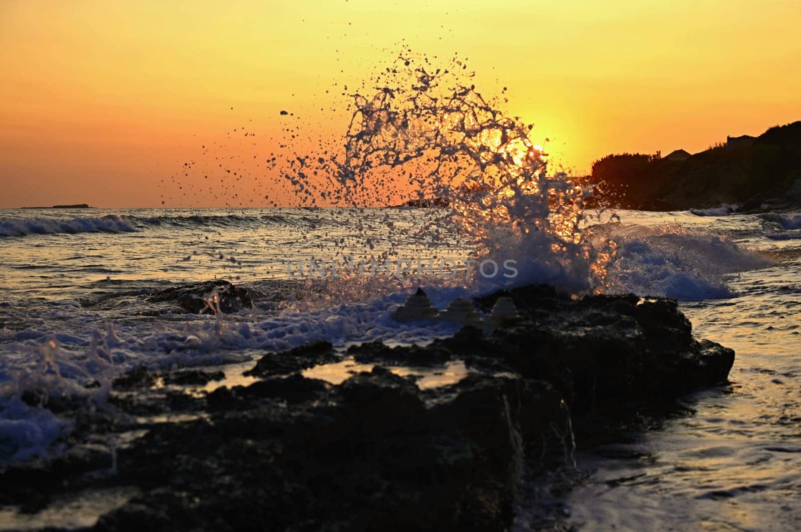 Beautiful sunset on the beach with the sea. Waves on the sea. Greece - Corfu island (Kerkyra) Agios Georgios. A concept for travel, holidays and summer vacations. 