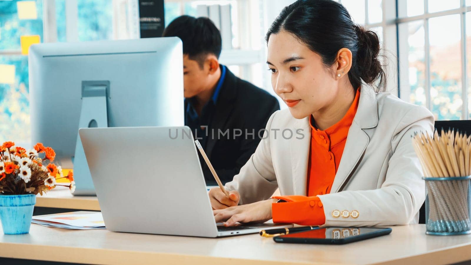 Business people working at table in modern office room while analyzing financial data report . Jivy