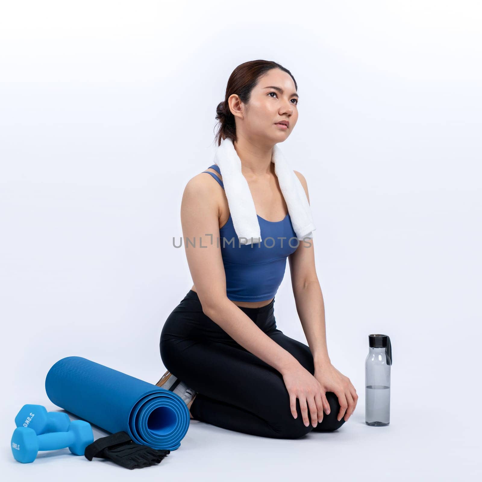 Athletic and sporty asian woman resting after intensive cardio workout training. Healthy exercising and fit body care lifestyle pursuit in studio shot isolated background. Vigorous