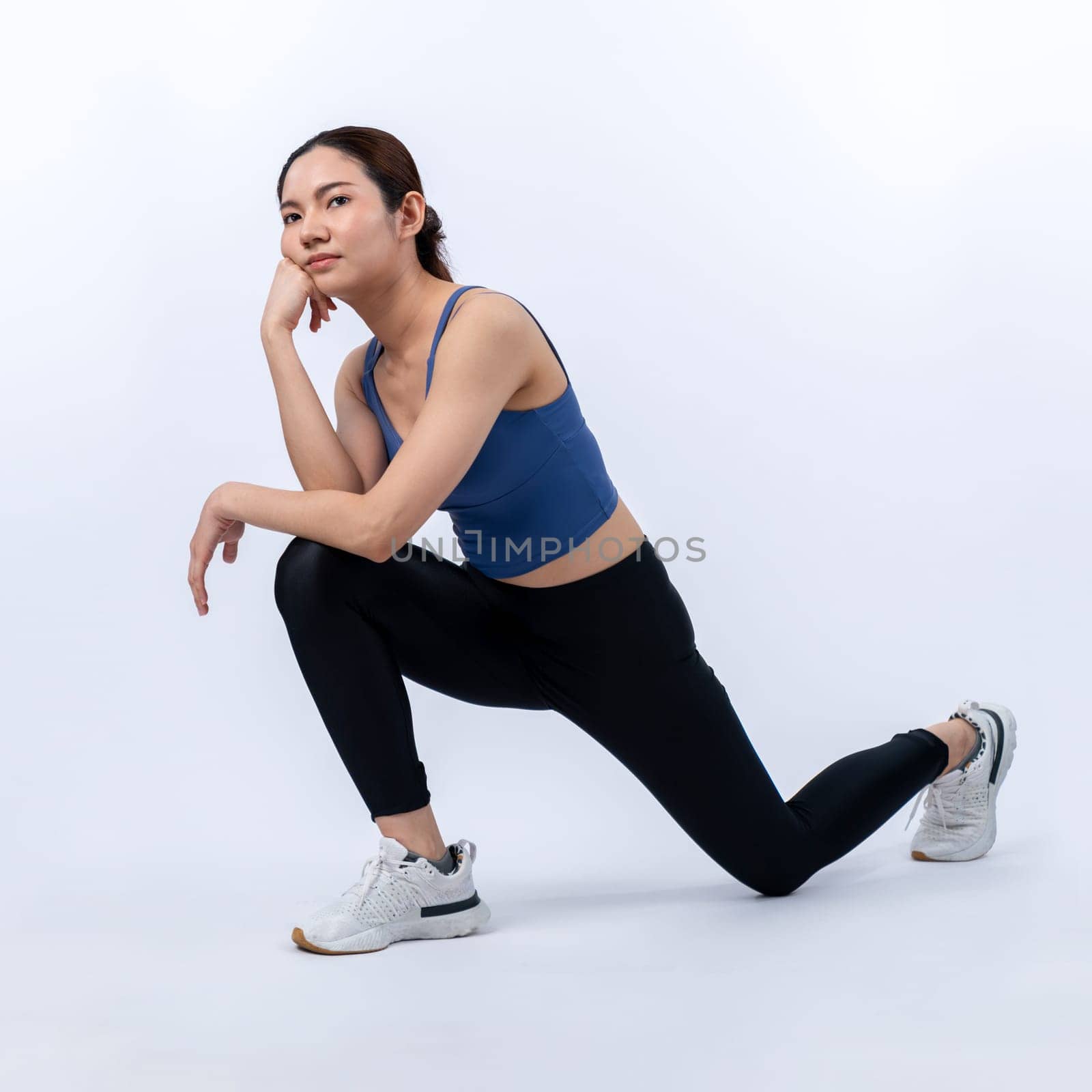 Young attractive asian woman in sportswear stretching before fitness exercise routine. Healthy body care workout with athletic woman warming up on studio shot isolated background. Vigorous