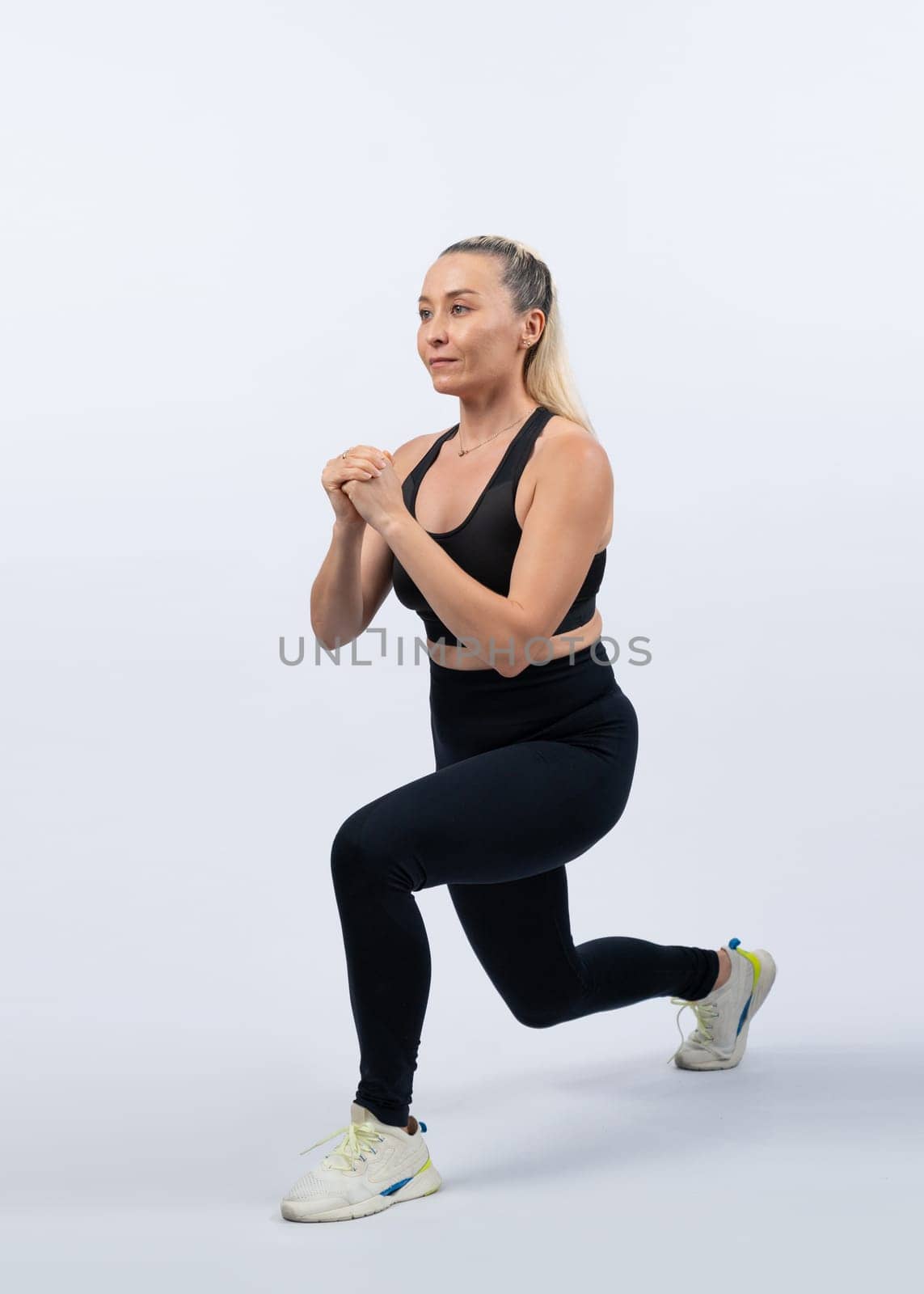 Active and fit physique senior woman warming up before exercise on isolated background. Healthy lifelong senior people with fitness healthy and sporty body care lifestyle concept. Clout