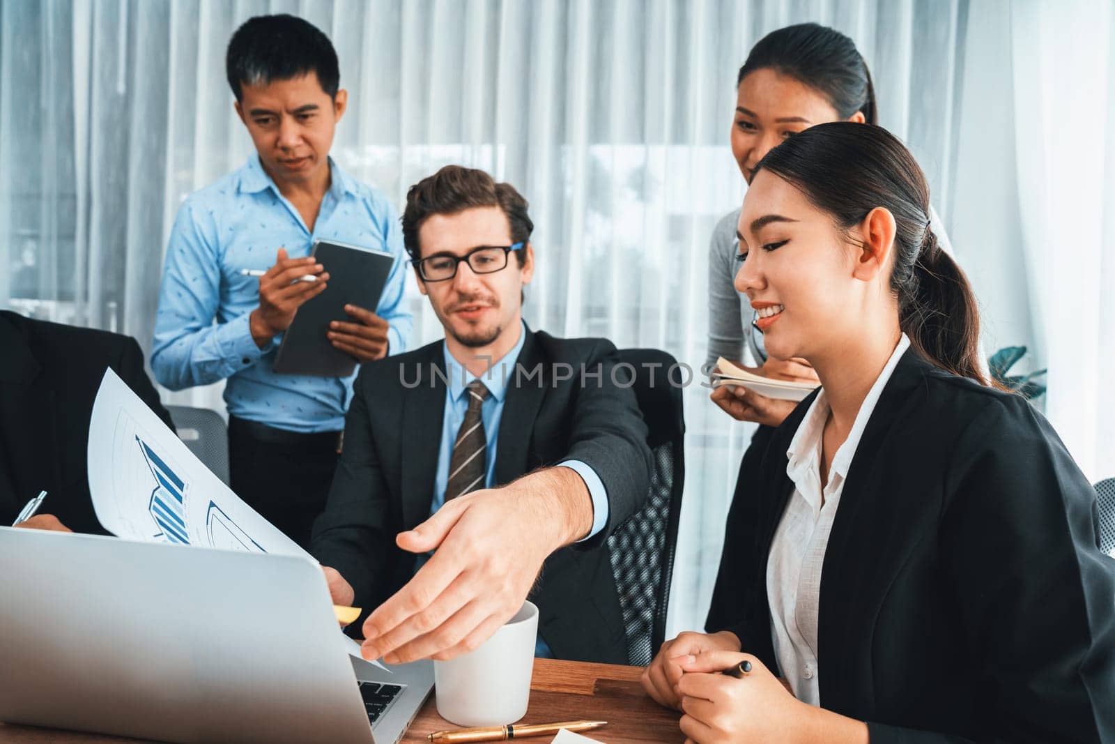 Diverse of business people from various ethnic group working in modern office environment. Productive and multi ethnic office workers engage in discussion for strategic business marketing. Habiliment