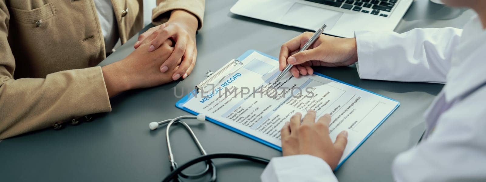 Doctor show medical diagnosis report and providing compassionate healthcare consultation to young patient in doctor clinic office. Doctor appointment and medical consult concept. Neoteric