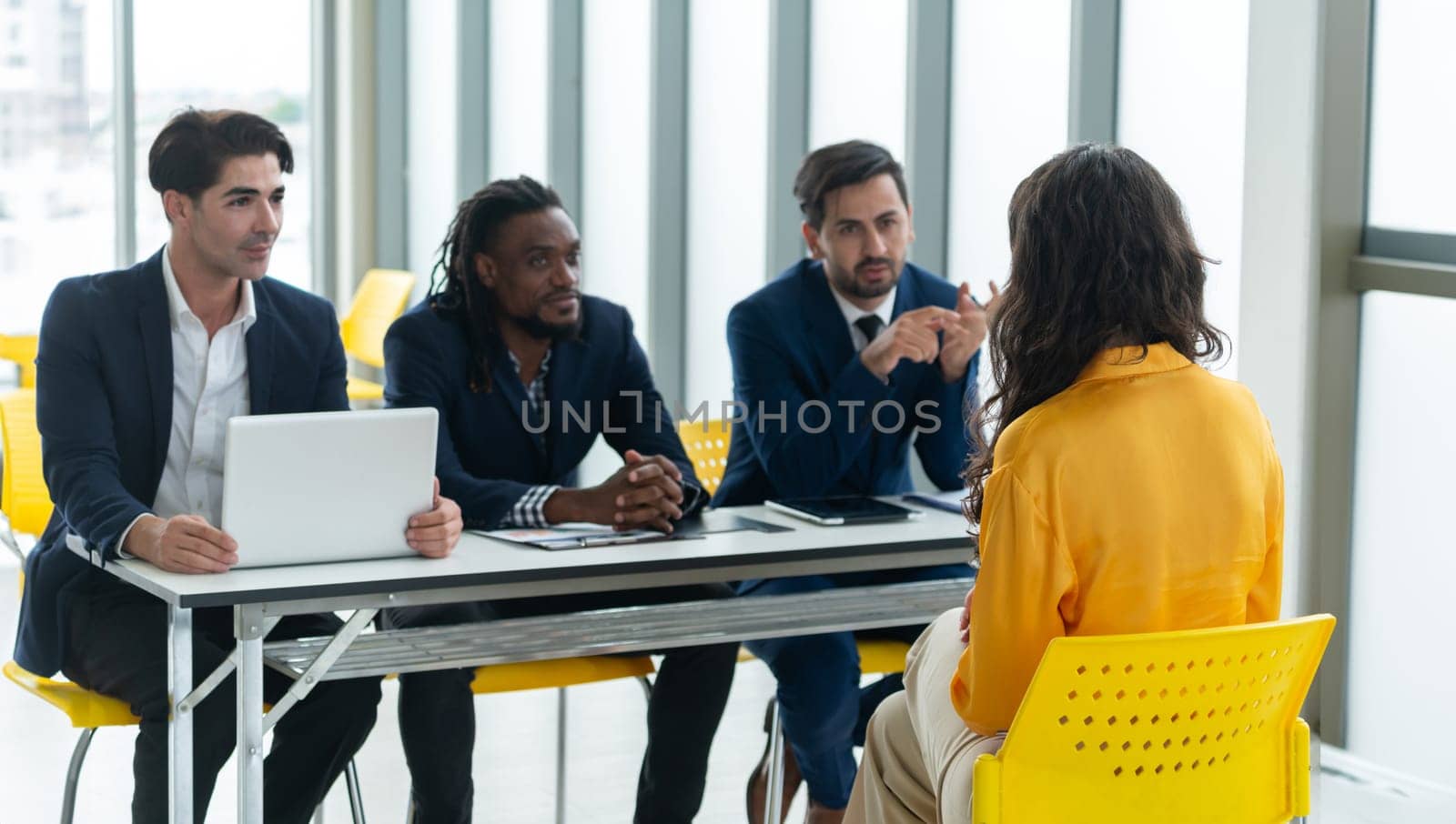 Diversity recruiters interview candidate at the bright office. A group of human resources professionals explaining an applicant for a new position. asking interviewee a question. Intellectual.