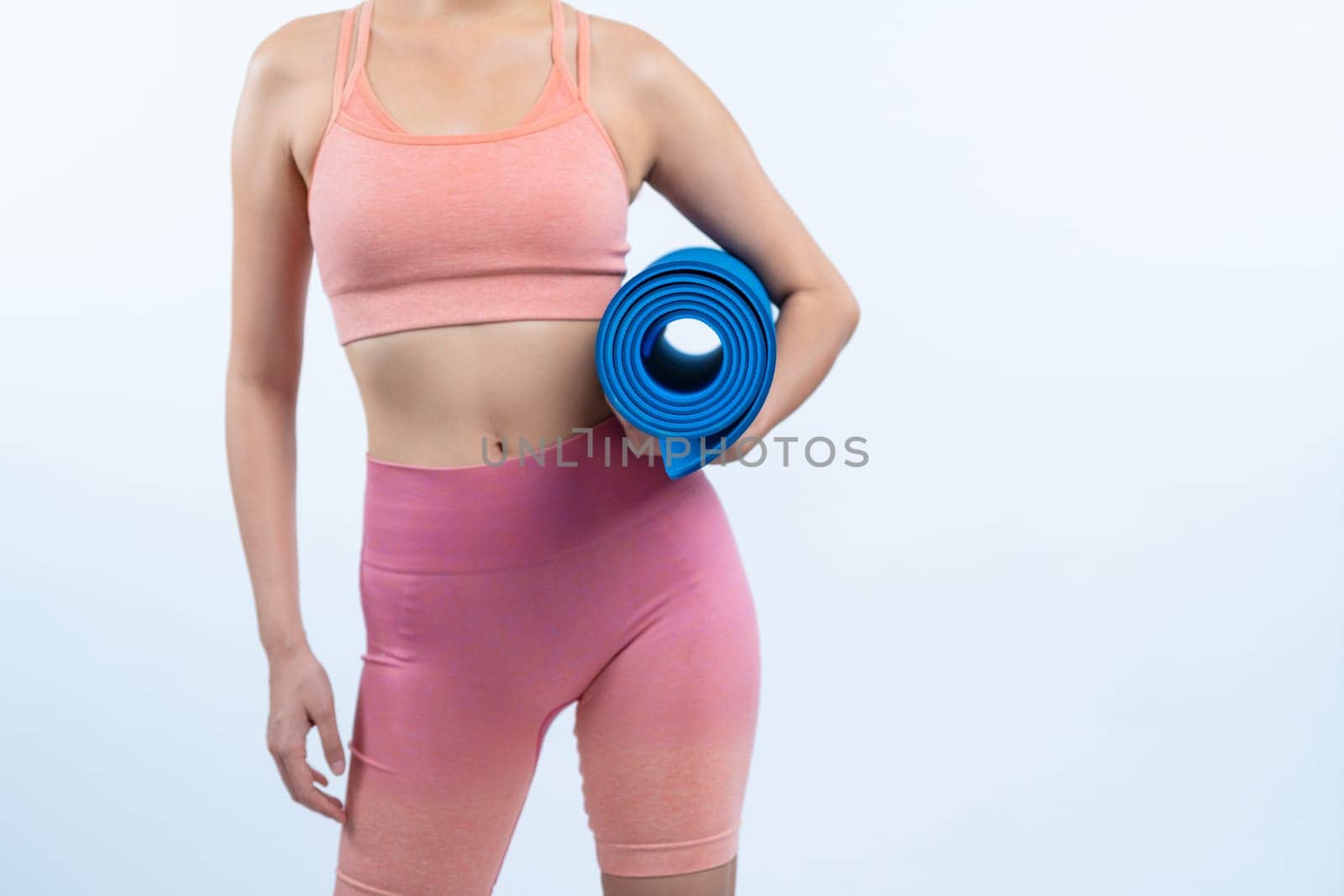 Young attractive asian woman portrait in sportswear with exercising mat. Healthy exercise and workout routine lifestyle concept. Studio shot isolated background. Vigorous