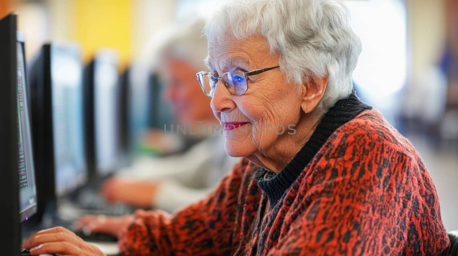 Focused senior citizen learning computer skills in a public space