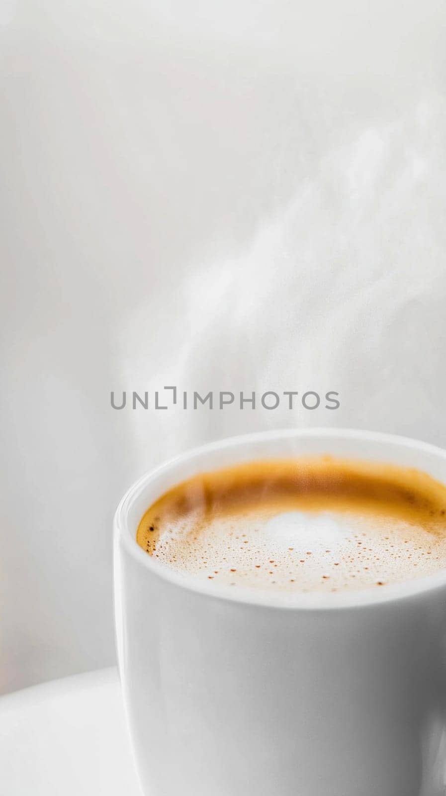Steaming cup of coffee creating aromatic atmosphere on white background