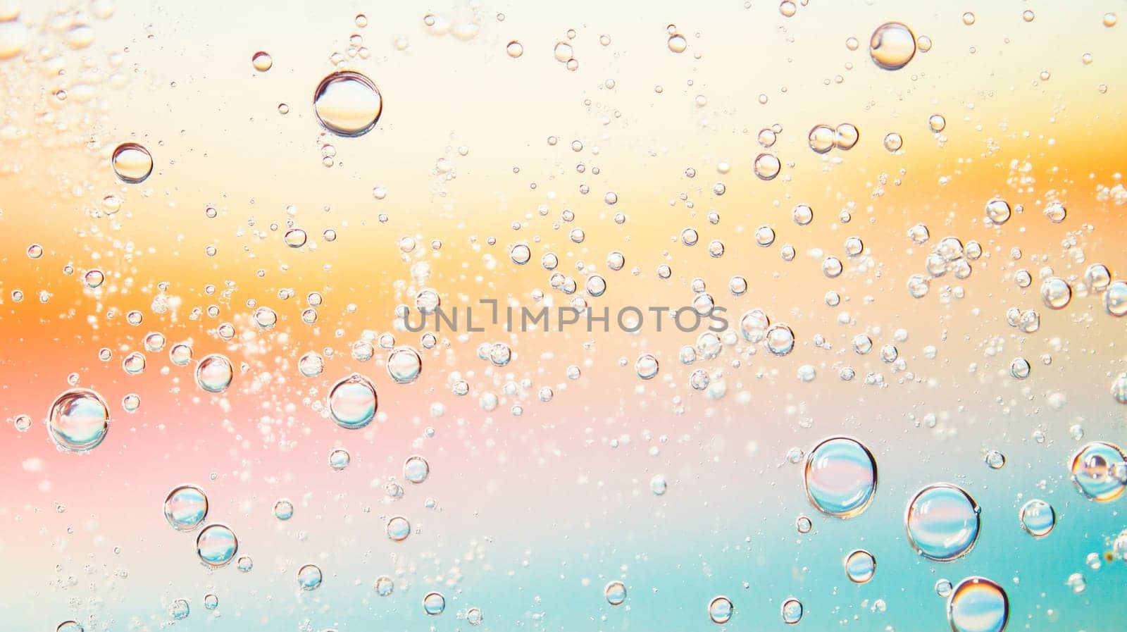 Beautiful macro shot of various sized bubbles floating on a gradient pastel background, creating a dreamy and abstract scene