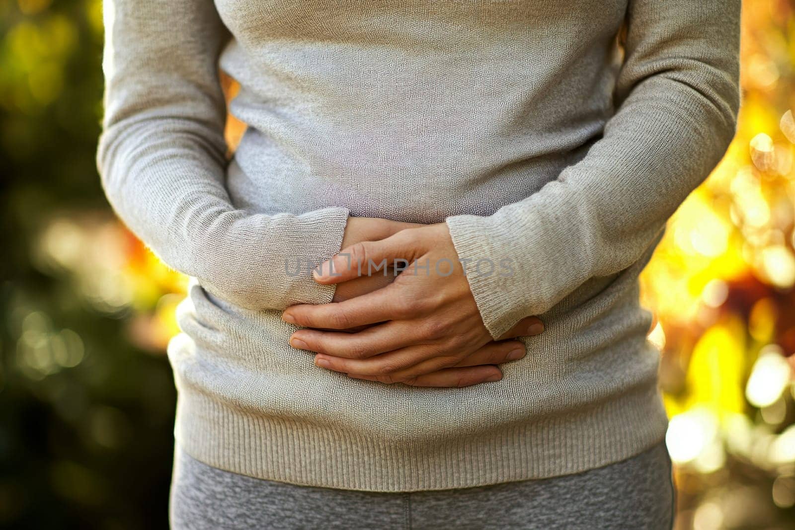 A person with a stomach ache. holding their stomach in pain. on white background. with white space.