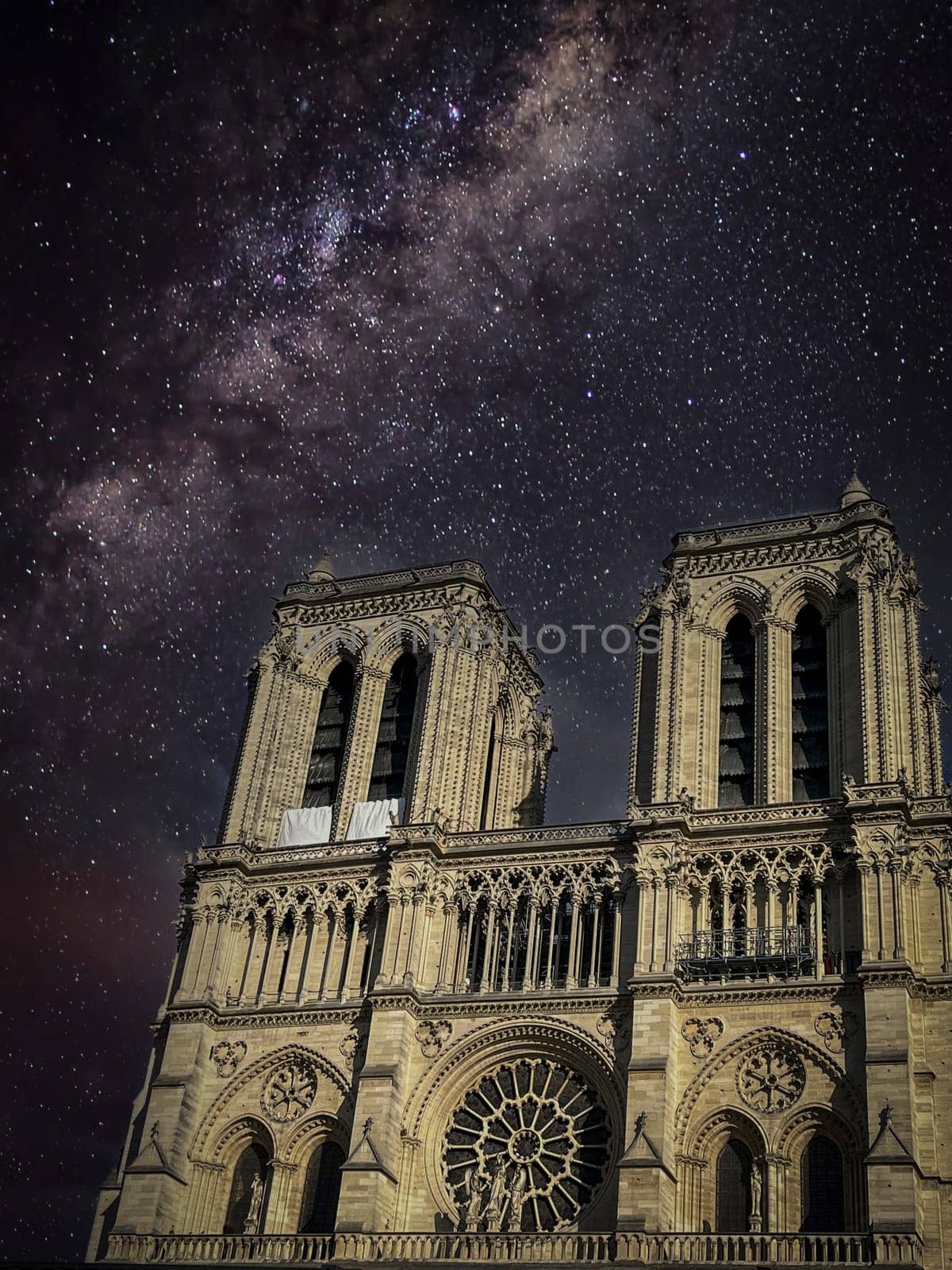 Notre dame cathedral, Paris on a cloudy evening under a starry sky, High quality photo