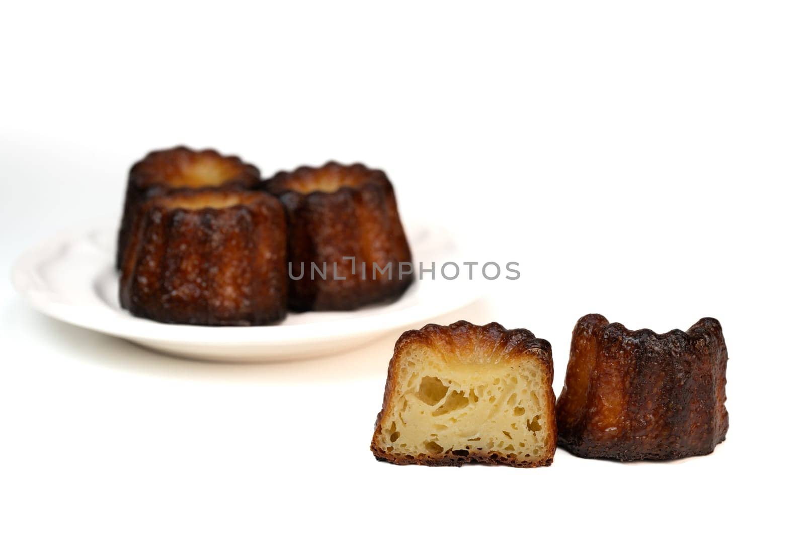Caneles de bordeaux, traditional French sweet dessert with white table background, High quality photo