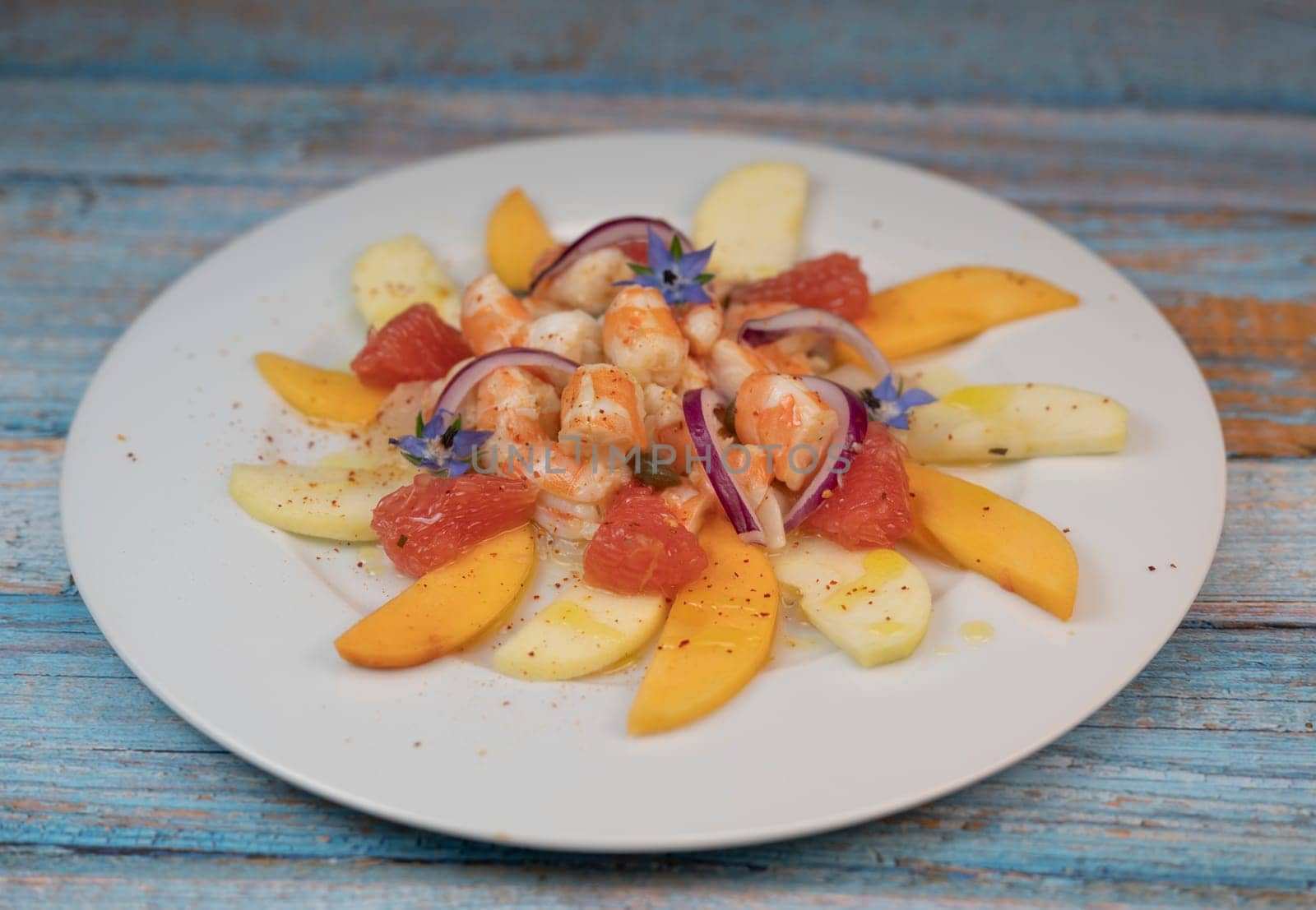 RECIPE CEVICHE OF SHRIMPS AND SCALLOPS WITH CITRUS FRUIT, LEMON, LIME, SQUEEZED ORANGE, GRAPEFRUIT AND FRUIT, PERSIMMON, APPLE, SEASONED WITH ESPELETTE PEPPER. High quality photo