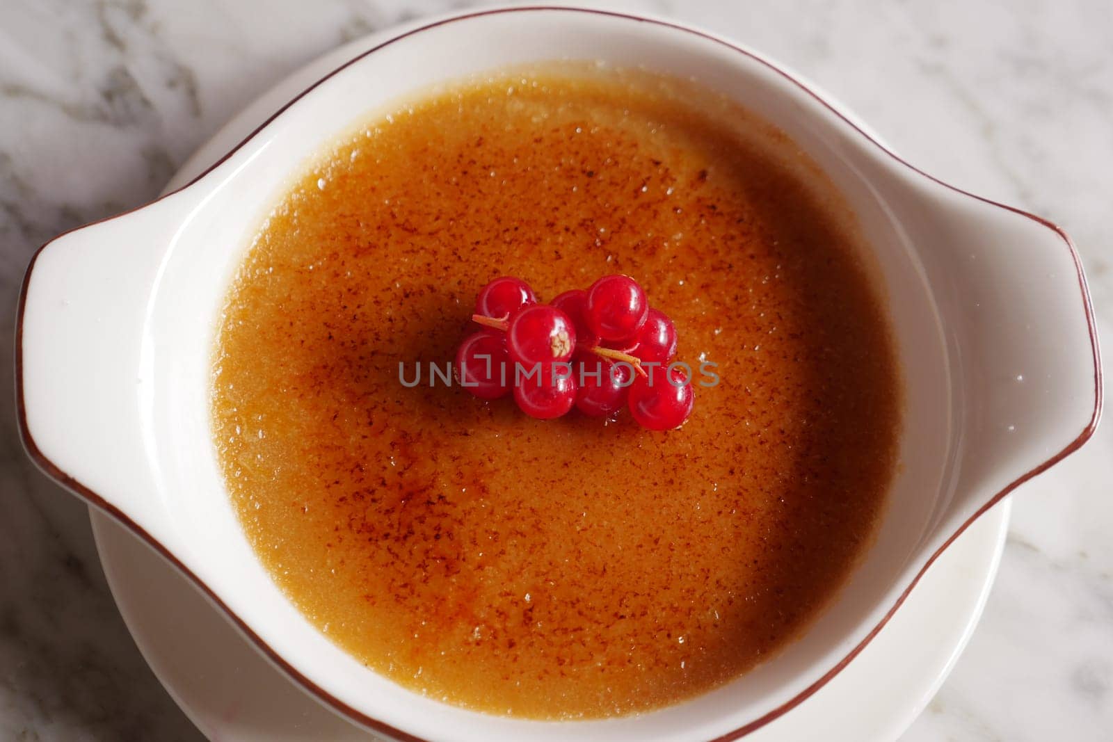 Caramel custard pudding on a plate on table ,