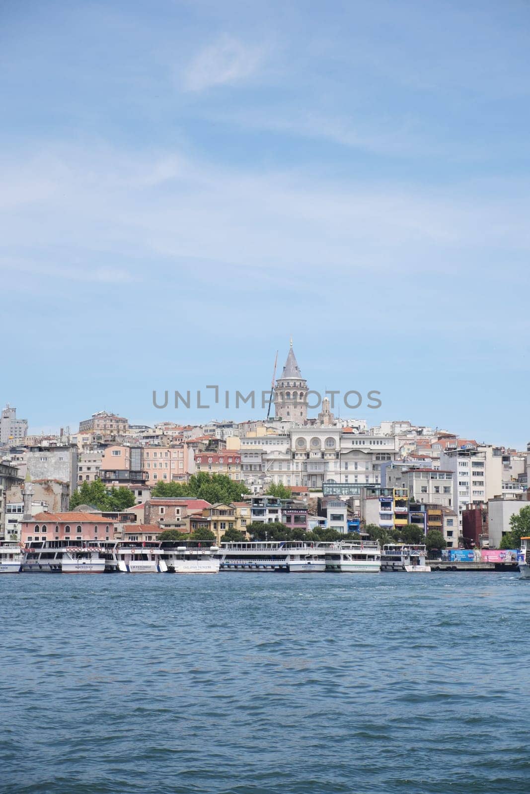 A stunning shot of the iconic Galata Tower overlooking the beautiful water in Istanbul