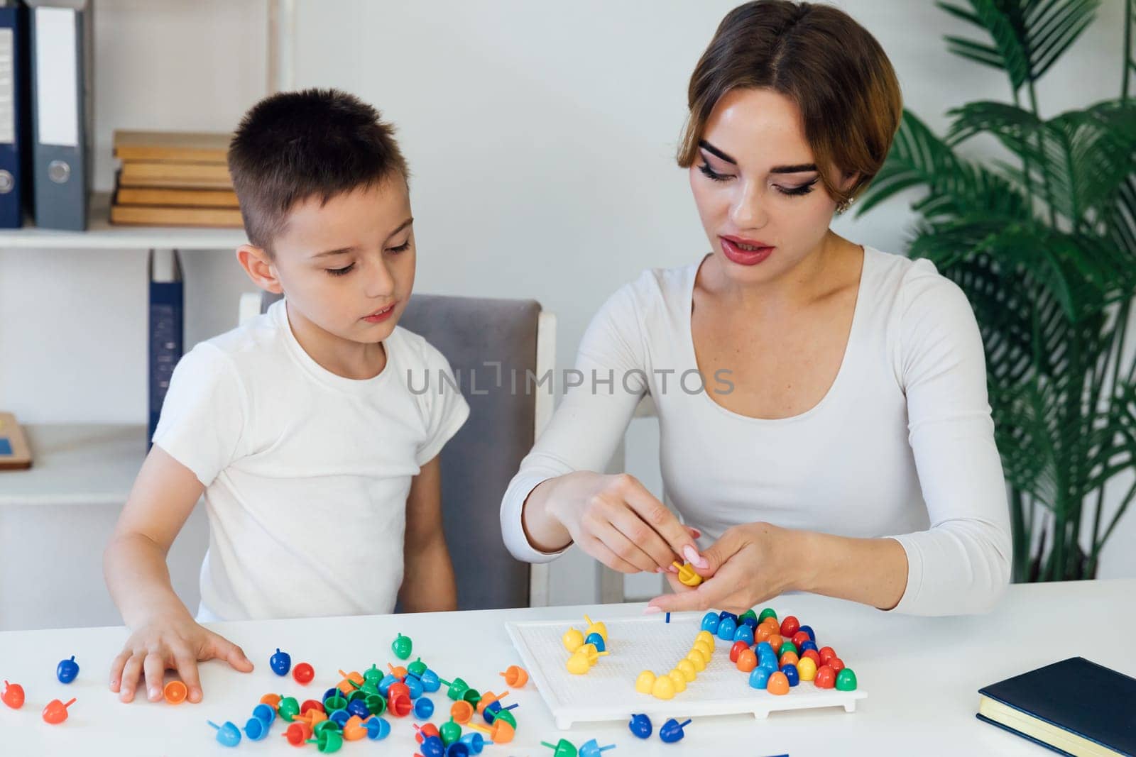 Teacher Playing Educational Games With Boy