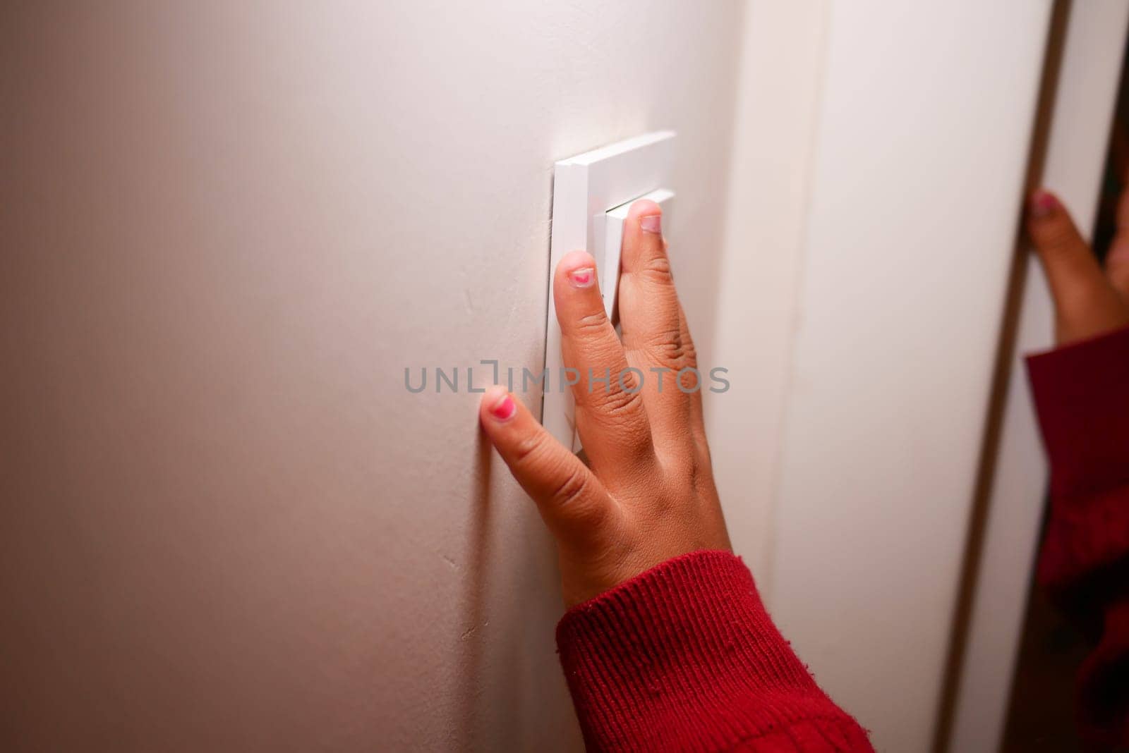 child finger turning on lighting switch with copyspace .