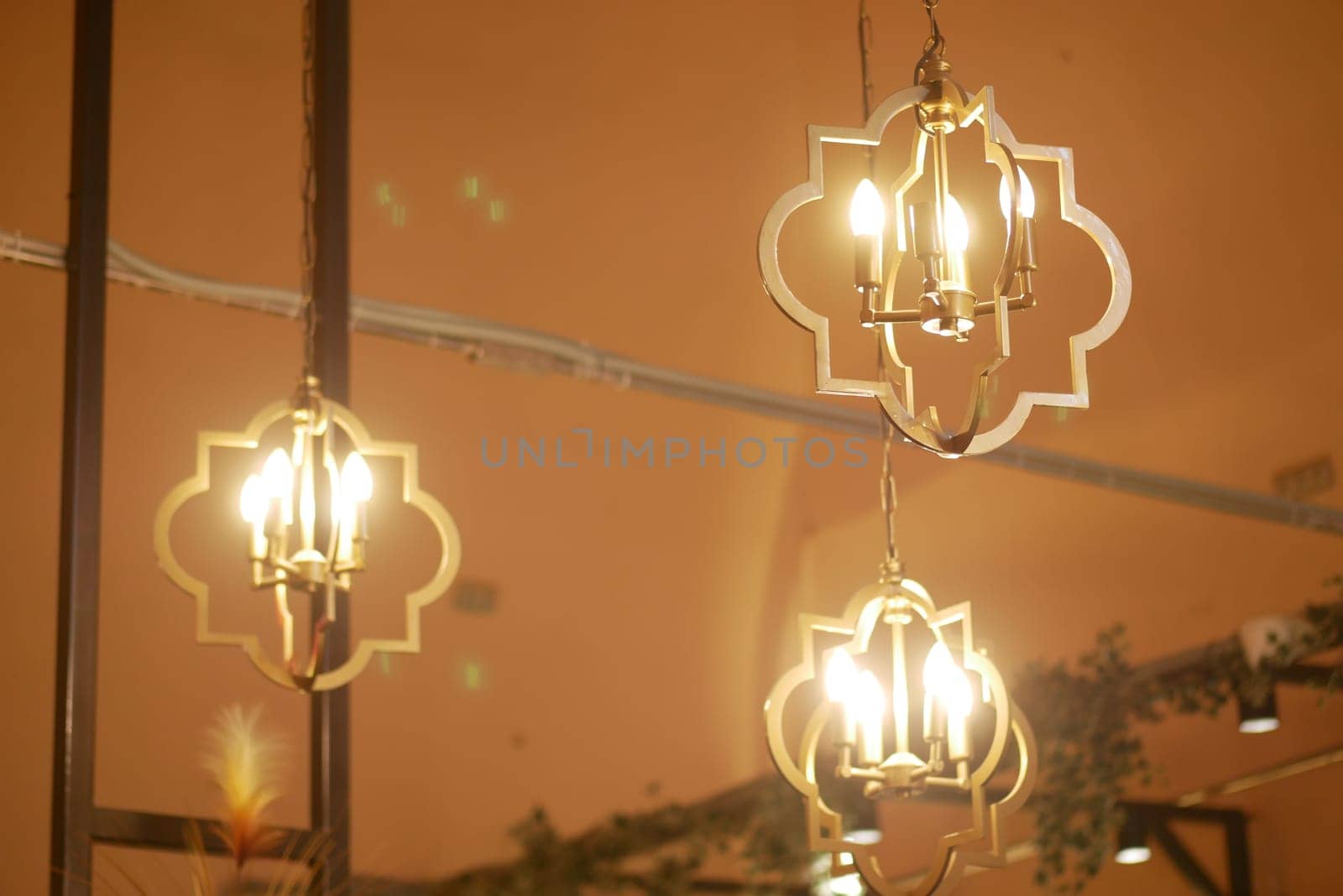 The beautifully designed lanterns emit a warm light that enhances a stylish interior decor