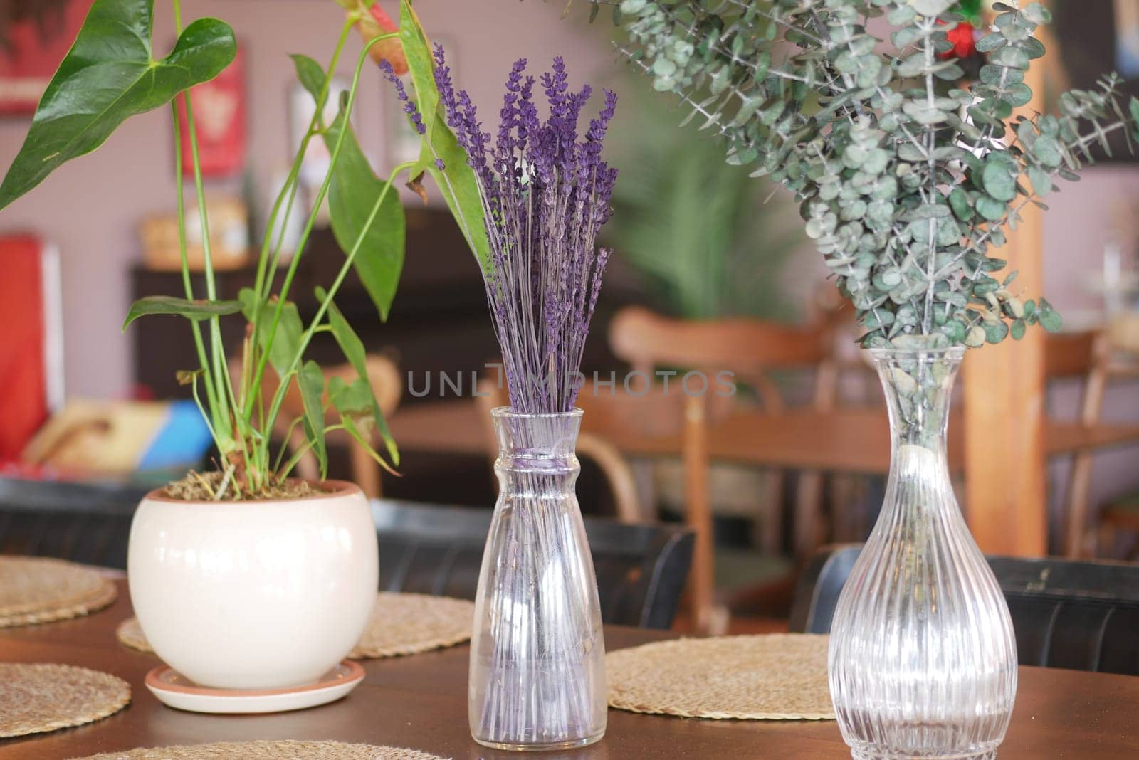 A beautiful display of dried flowers and vibrant green plants on a lovely dining table