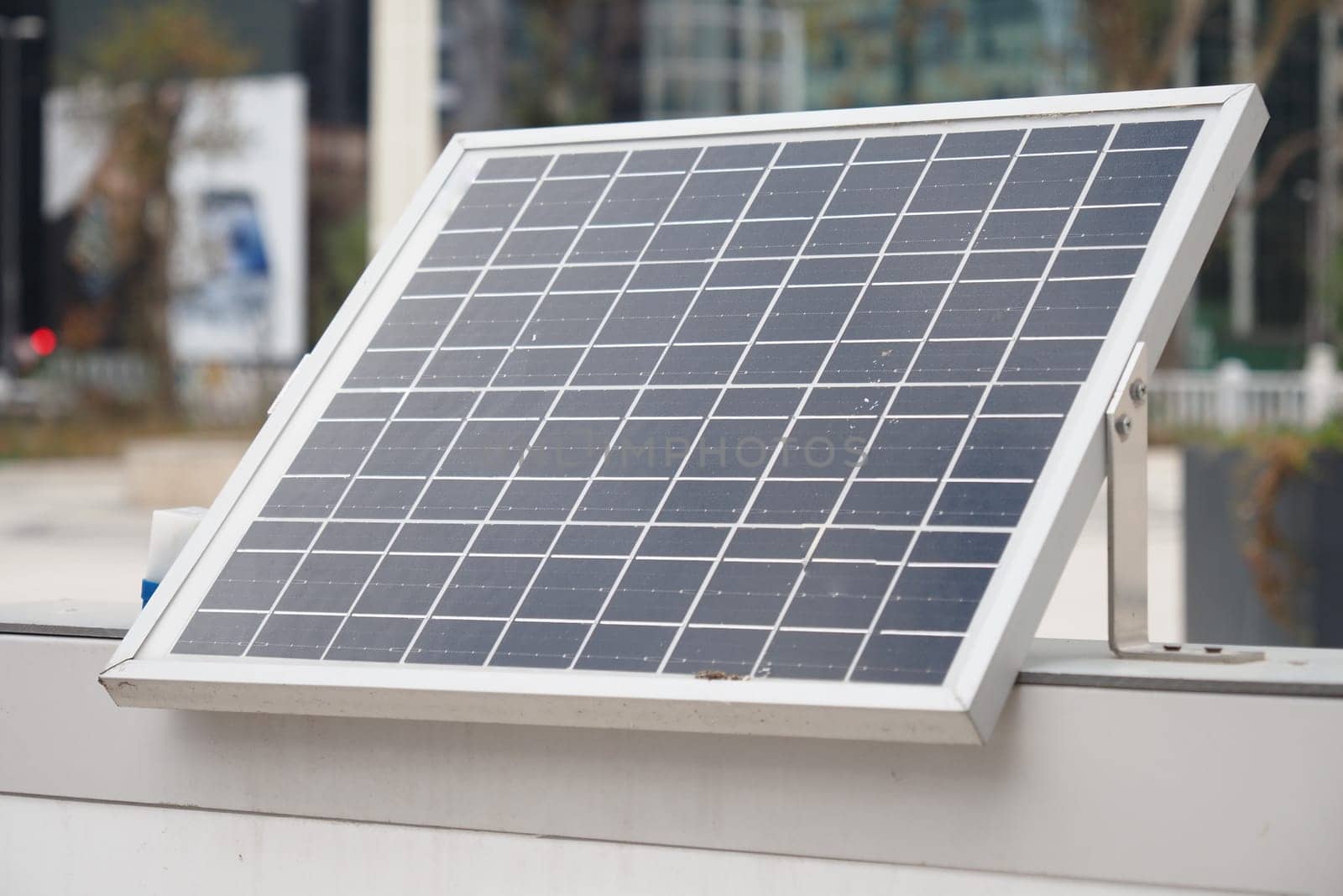 A modern solar panel among skyscrapers, highlighting the use of renewable energy