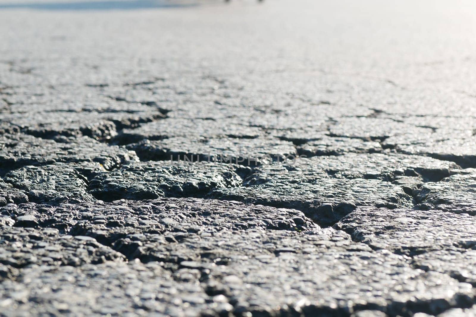 A detailed closeup view of a cracked surface that reflects light in a beautiful manner