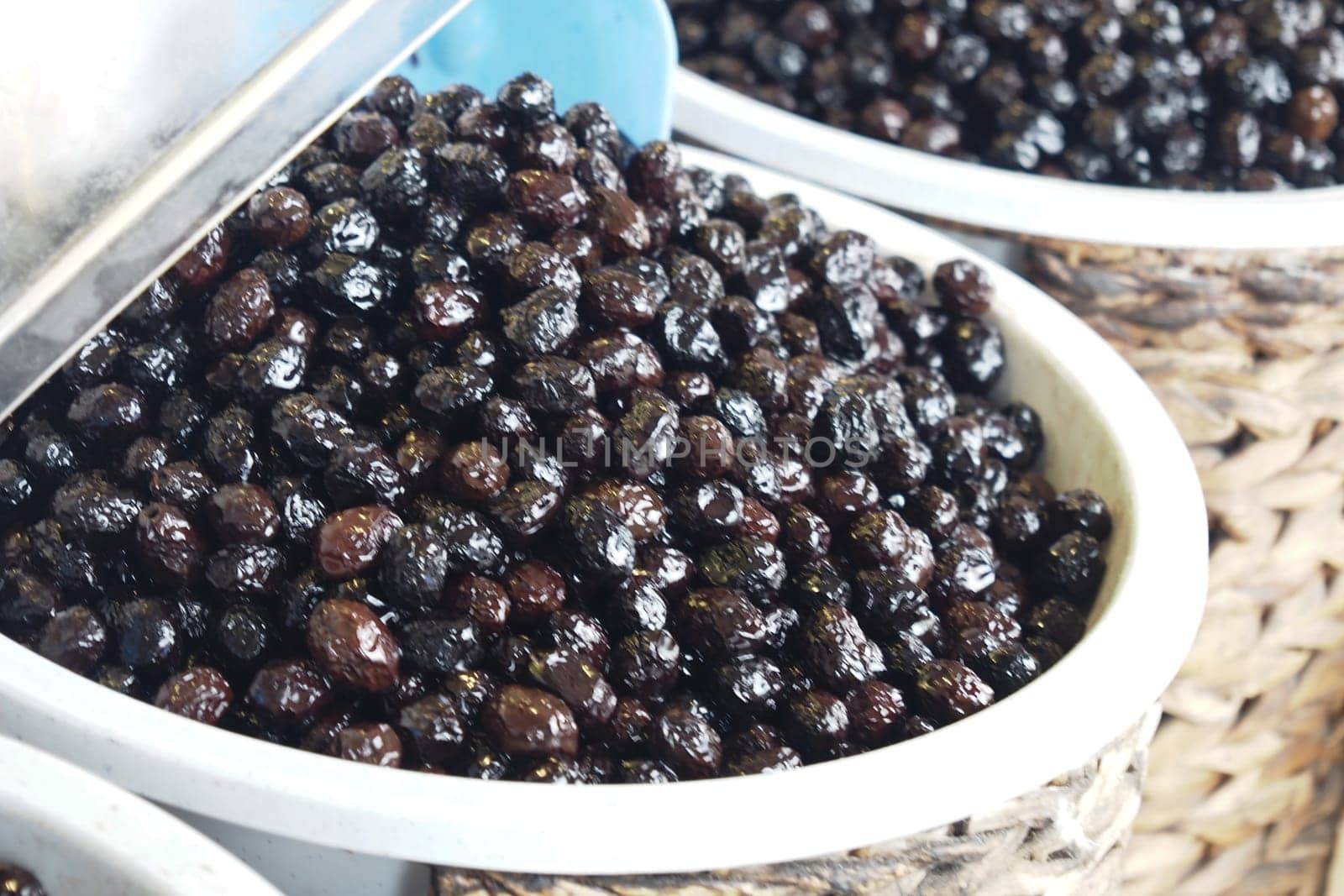 Buckets of olives for sale street food market.