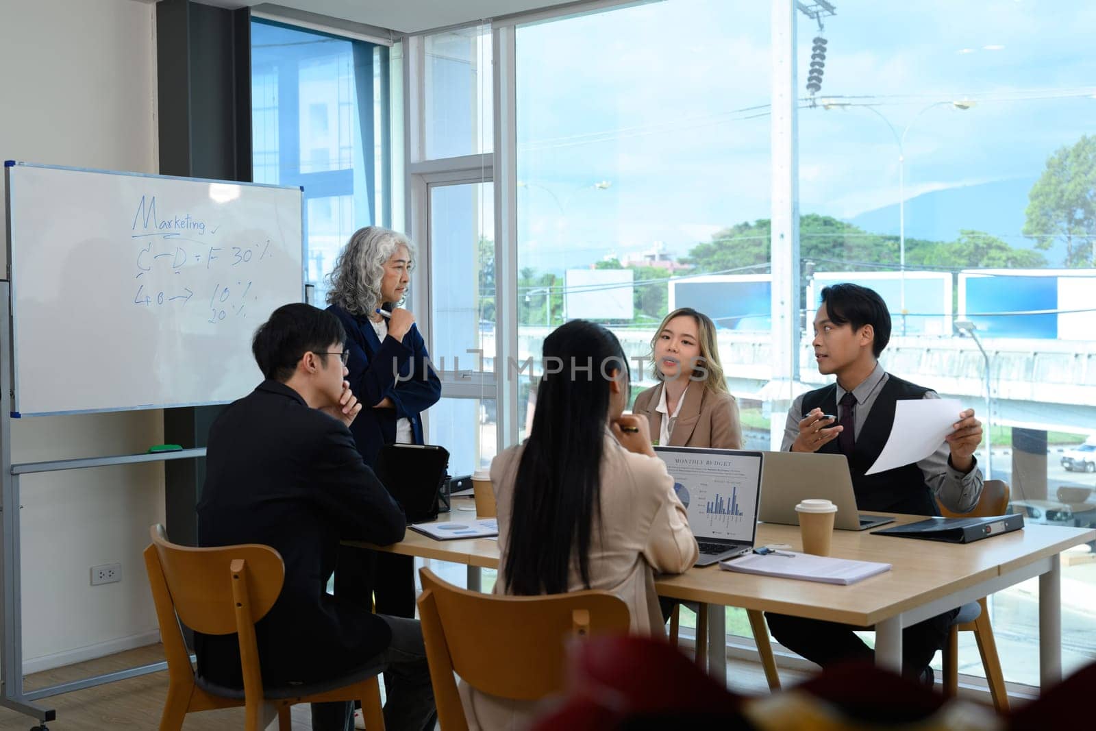 Group of professionals businesspeople collaborating on a marketing strategy in a modern office.