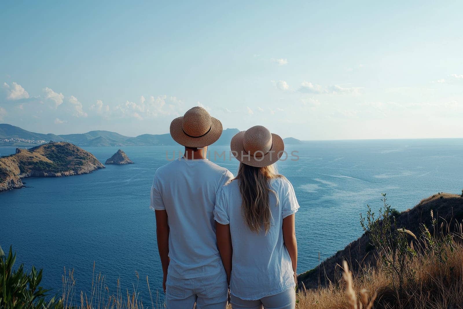 young couple of travelers on a hill with stunning views to scenic sea vacation..
